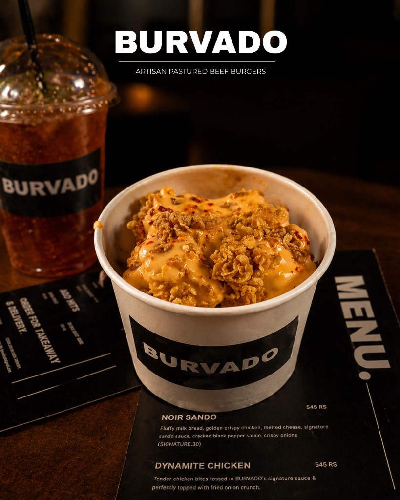 Dynamite Chicken in a small bowl, with a Burvado drink