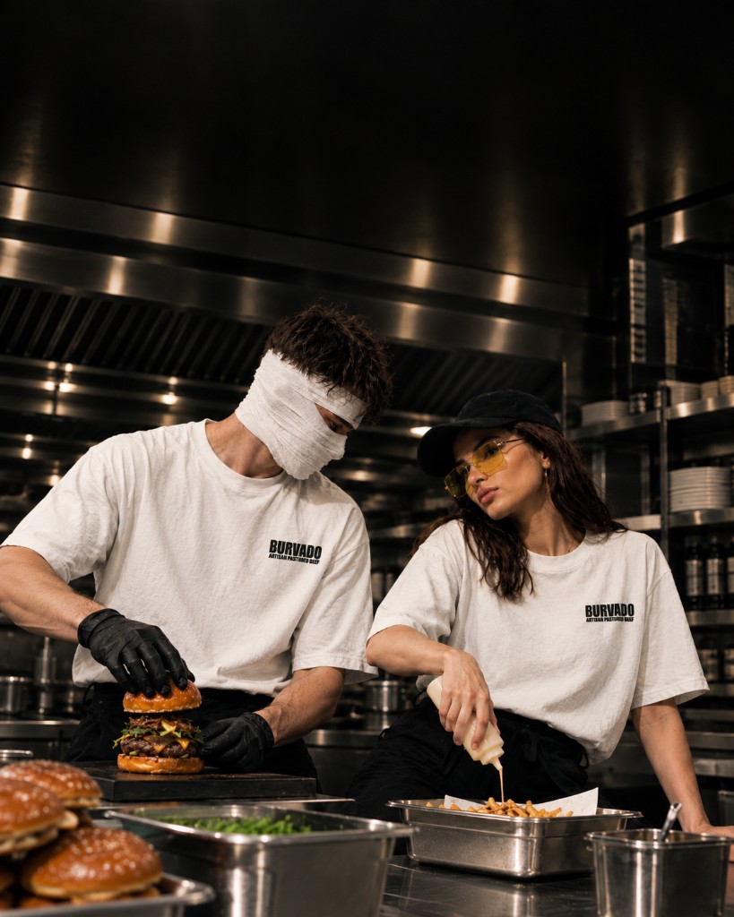 Two cooks finishing an order on the pass